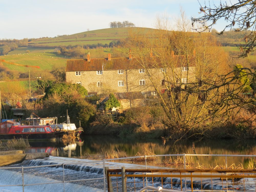 Kelston MIlls, the River Avon - and Kelston Round Hill – an ornamentally planted ‘eye catcher’ for Brown’s Kelston Park. The 18th century ride from Kelston Park House to the Round Hill was to view the magnificent sweep of the River Avon, and the distant Welsh Hills.